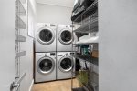 Full laundry room with two full size washers and two full size dryers